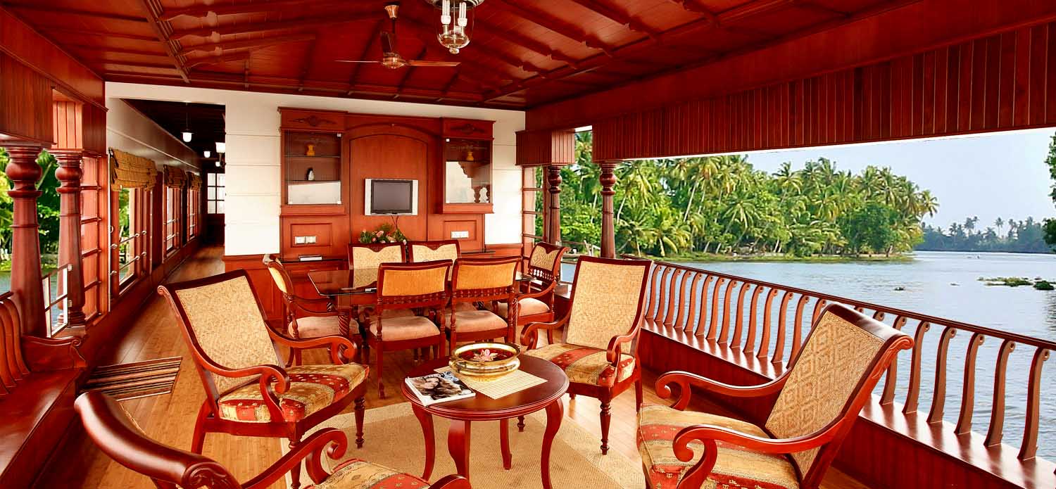 "Idyllic Kerala backwaters scene with traditional houseboat gliding peacefully along lush greenery and palm-fringed waterways."